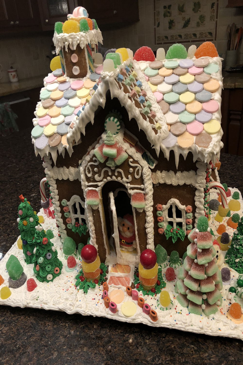 Gingerbread house with Necco wafer roof, watermelon slice tree