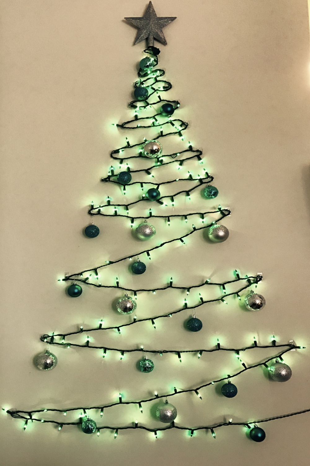 Wall Christmas tree made of green lights, clear command strip