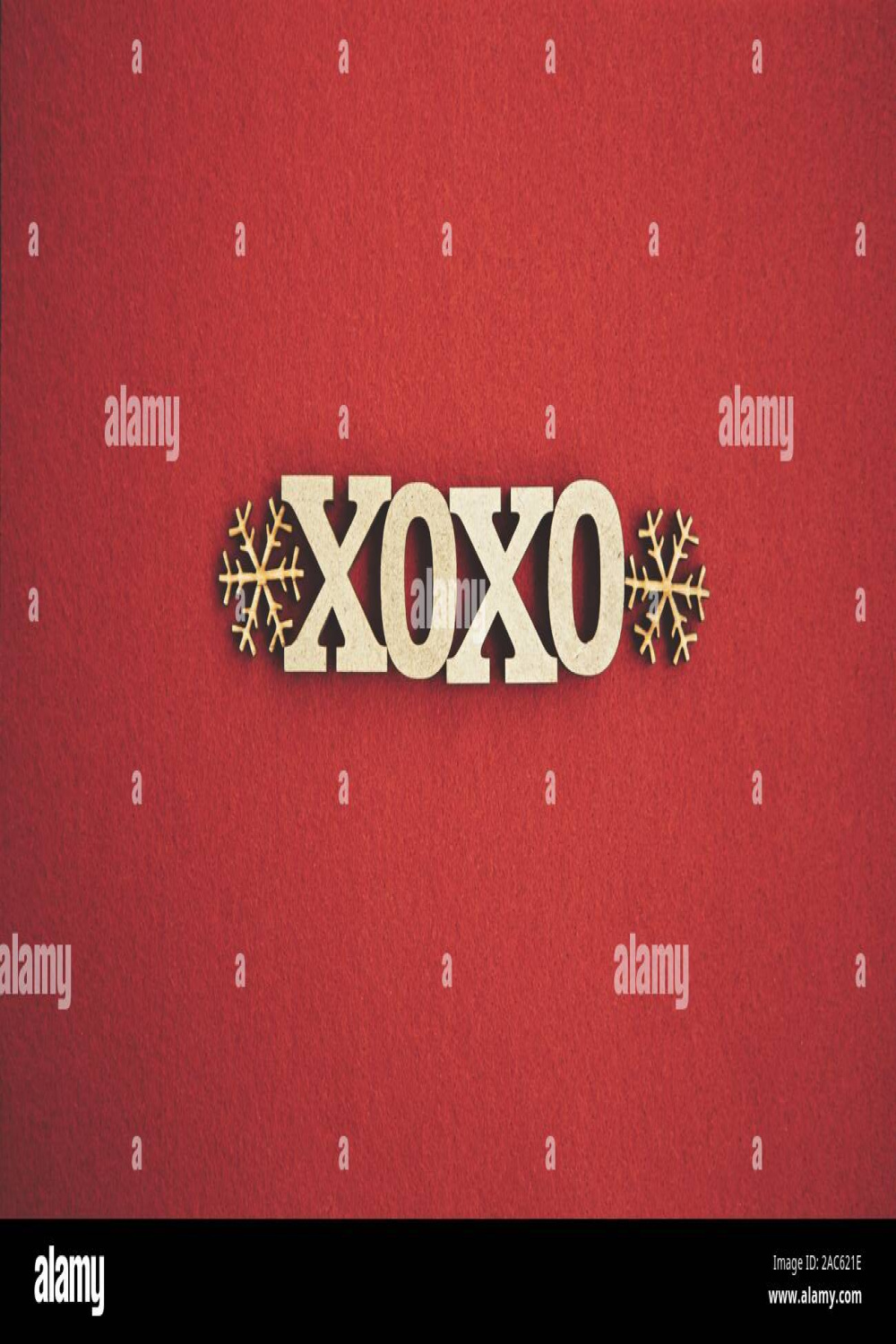 Red Christmas background with rustic wooden XOXO letters and hand